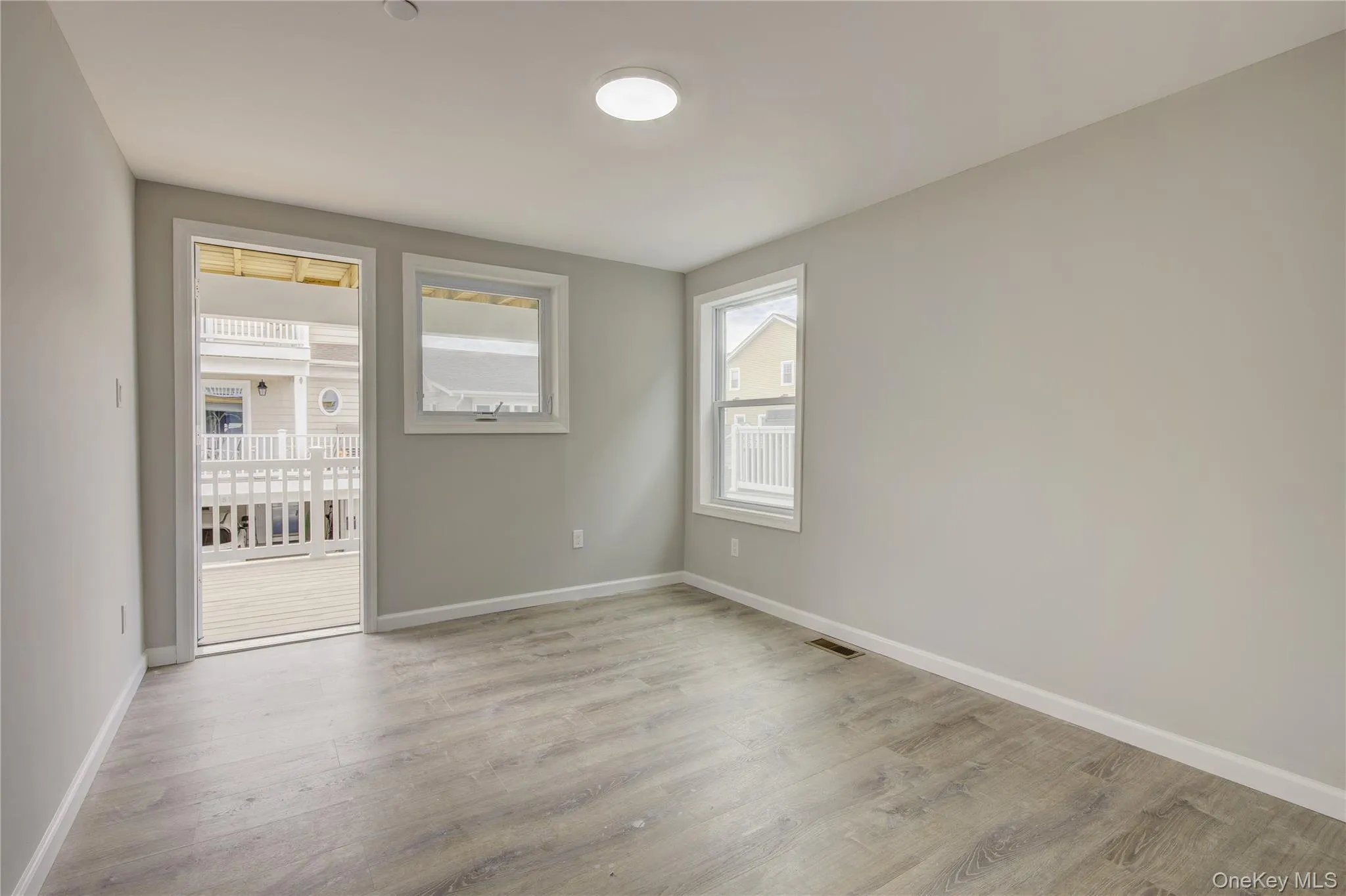 Empty room featuring baseboards and light wood-style floors Empty room featuring baseboards and light wood-style floors