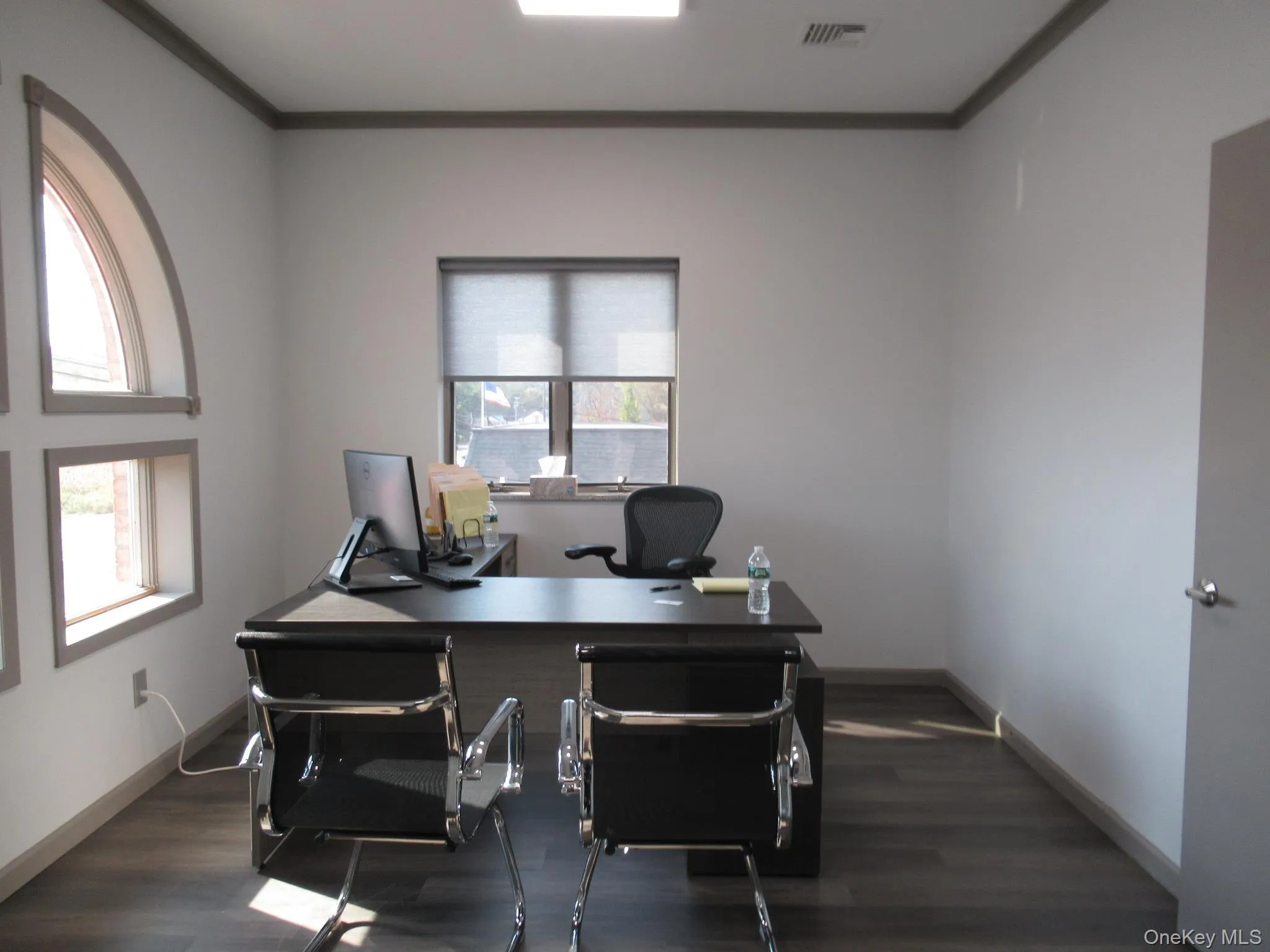 Office with dark wood-style flooring and ornamental molding Office with dark wood-style flooring and ornamental molding