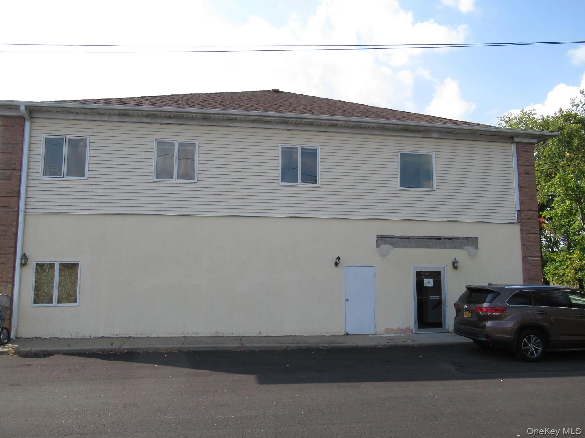 Rear view of house featuring stucco siding Rear view of house featuring stucco siding