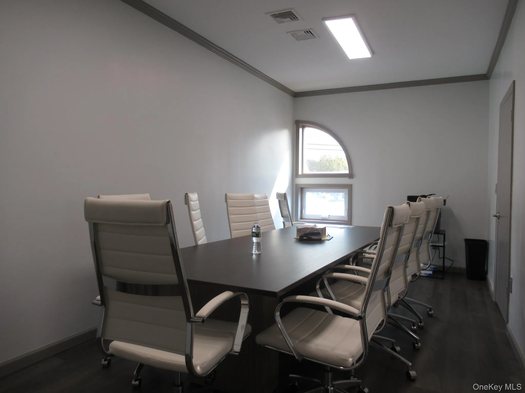 Office space with dark wood-type flooring and crown molding Office space with dark wood-type flooring and crown molding
