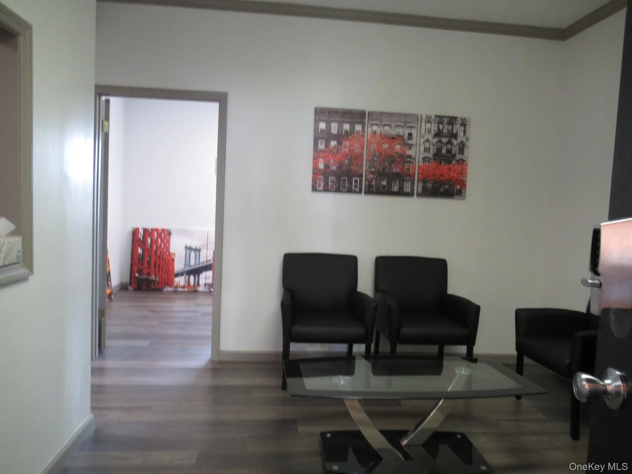 Sitting room with dark wood-style flooring and baseboards Sitting room with dark wood-style flooring and baseboards