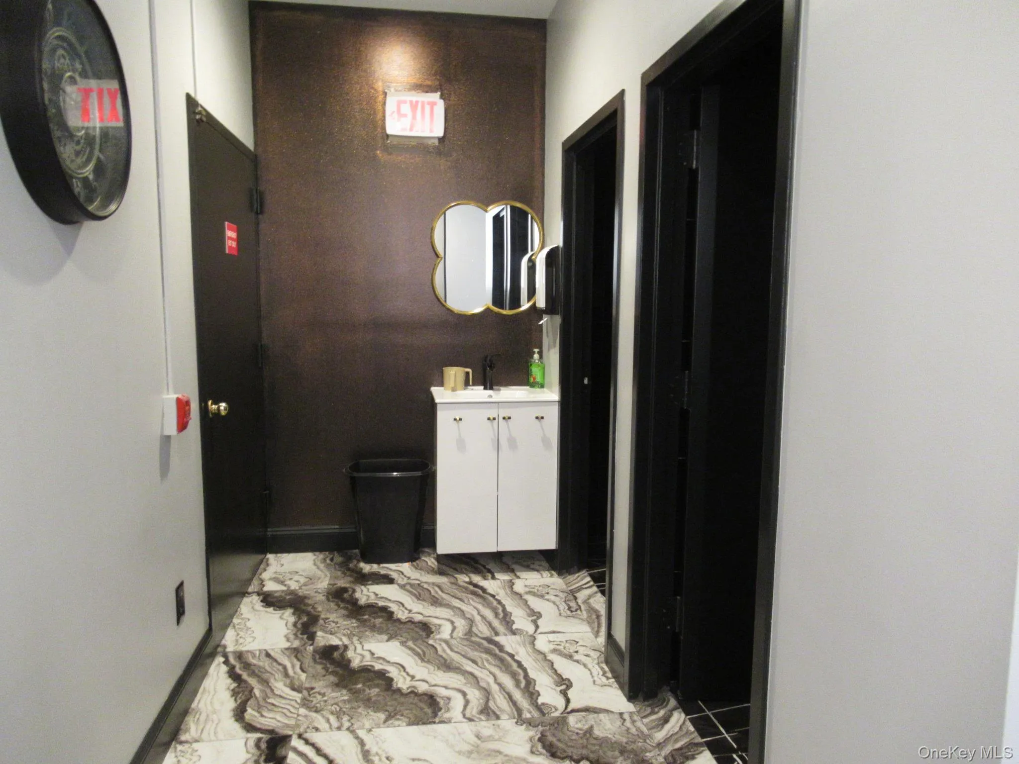 Hall with light marble finish floors and a sink Hall with light marble finish floors and a sink