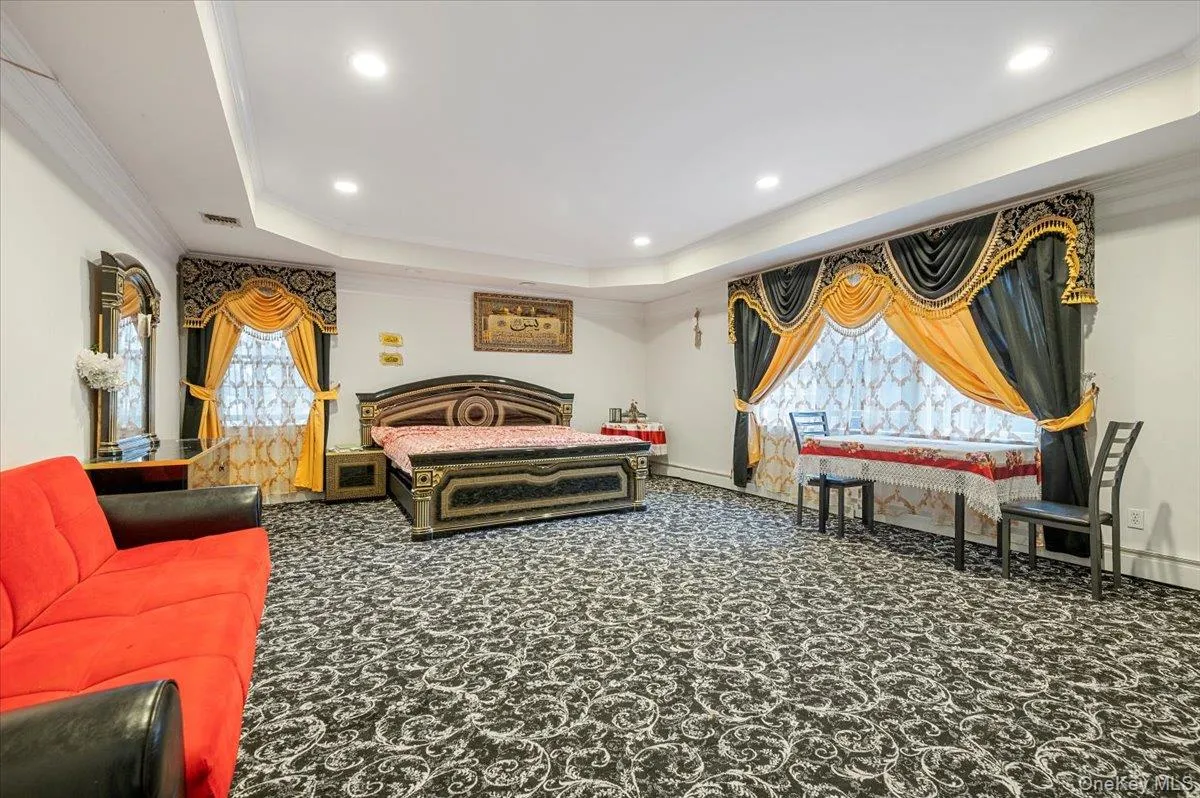 Carpeted Primary bedroom featuring a raised ceiling, crown molding, and recessed lighting Carpeted Primary bedroom featuring a raised ceiling, crown molding, and recessed lighting