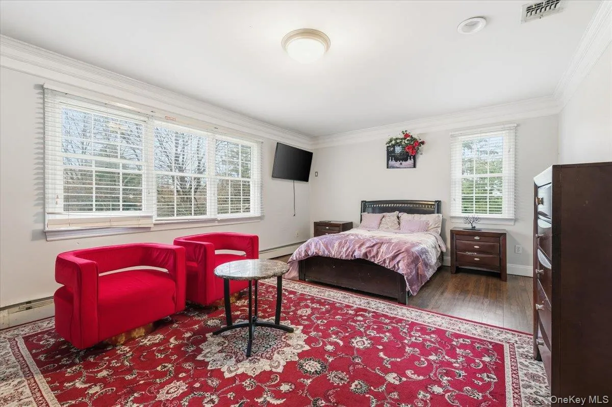2nd floor Bedroom #5 with crown molding, hardwood / wood-style flooring, and a baseboard radiator 2nd floor Bedroom #5 with crown molding, hardwood / wood-style flooring, and a baseboard radiator