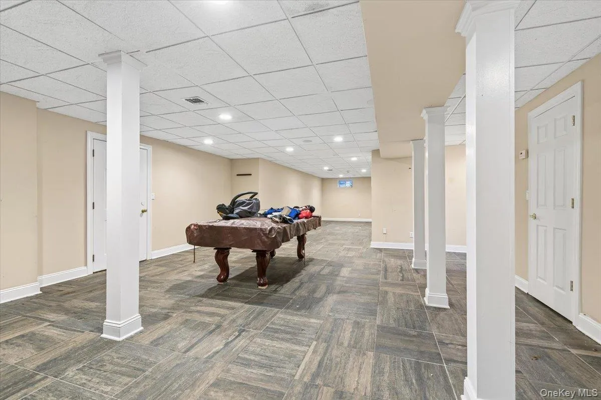 Basement Playroom featuring billiards table, a drop ceiling, and recessed lighting Basement Playroom featuring billiards table, a drop ceiling, and recessed lighting
