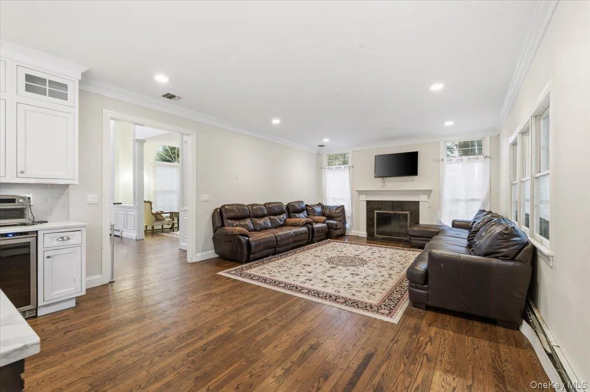 Family Room with a crown molding, recessed lighting, and fireplace Family Room with a crown molding, recessed lighting, and fireplace