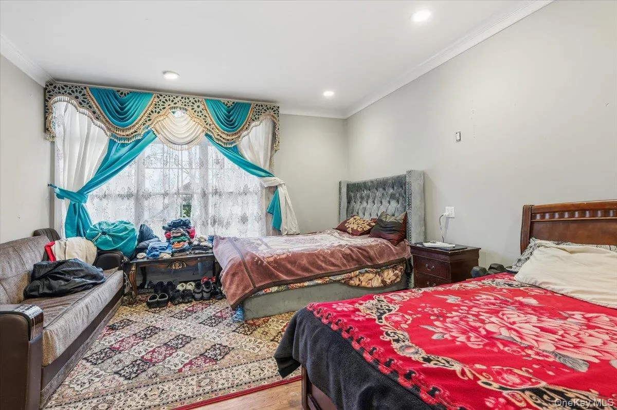 1st Floor Bedroom or Office featuring crown molding and wood finished floors 1st Floor Bedroom or Office featuring crown molding and wood finished floors