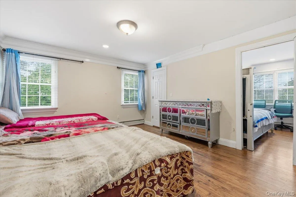 2nd floor Bedroom #3 featuring multiple windows, dark wood finished floors, crown molding, baseboard heating, and recessed lighting 2nd floor Bedroom #3 featuring multiple windows, dark wood finished floors, crown molding, baseboard heating, and recessed lighting