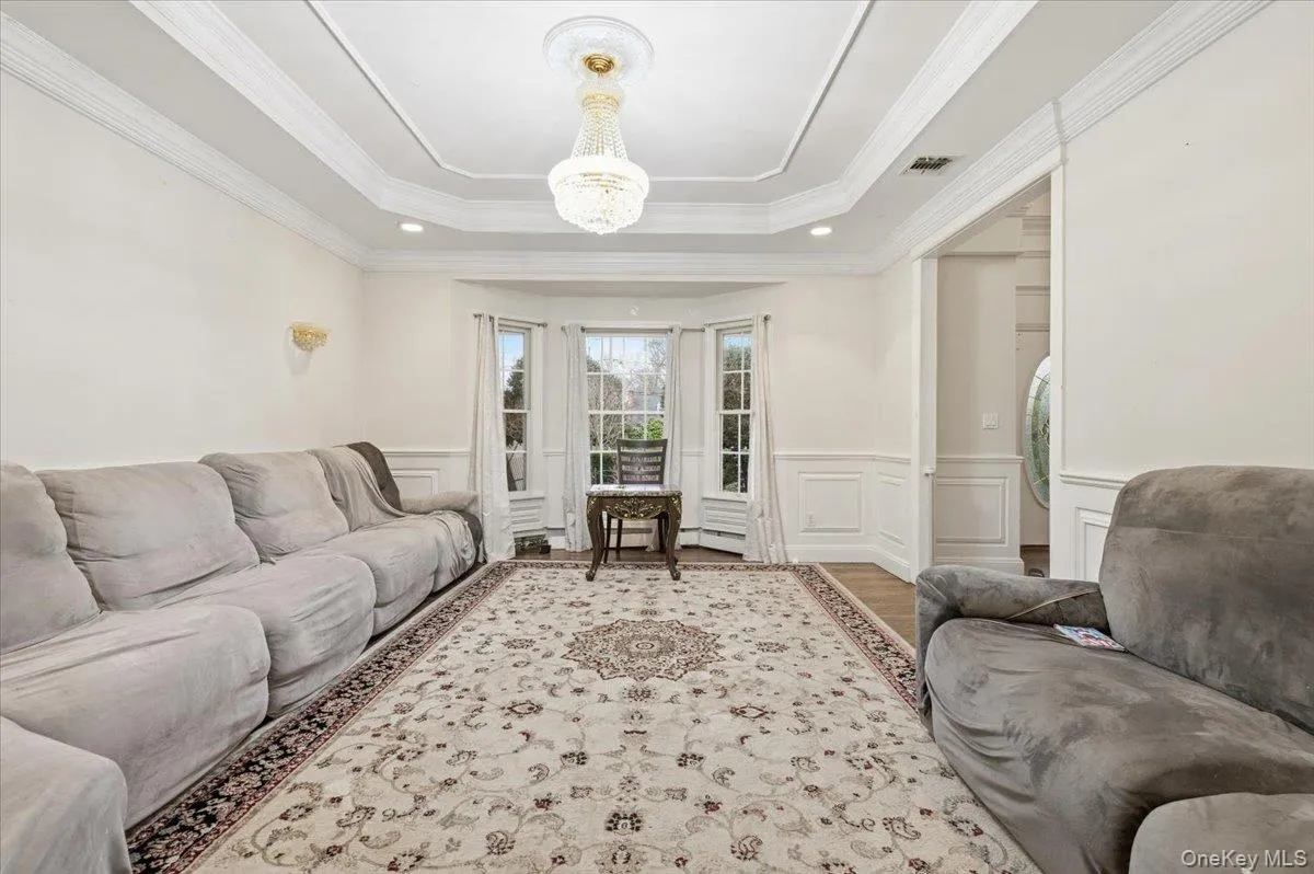 Dining room with a decorative wall, a wainscoted wall, crown molding, and tray ceiling Dining room with a decorative wall, a wainscoted wall, crown molding, and tray ceiling