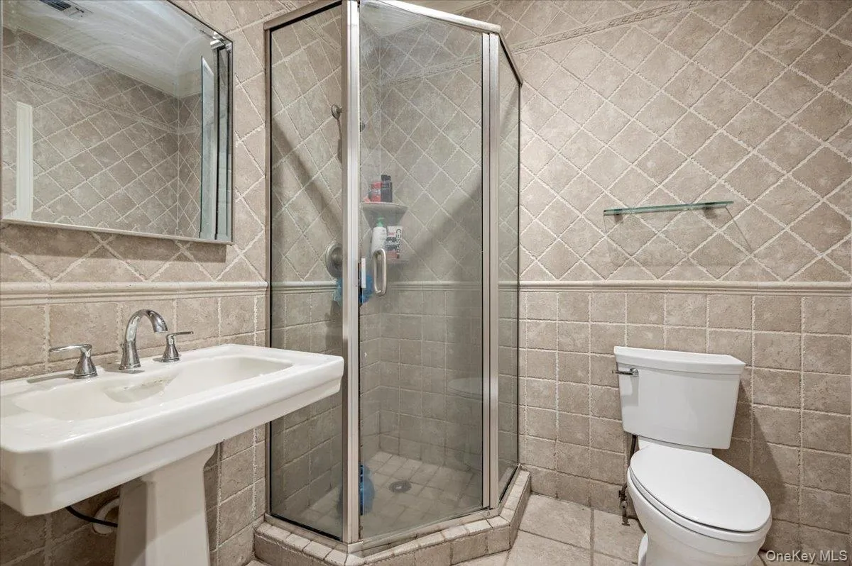 1st floor Bathroom with tile walls and a stall shower 1st floor Bathroom with tile walls and a stall shower