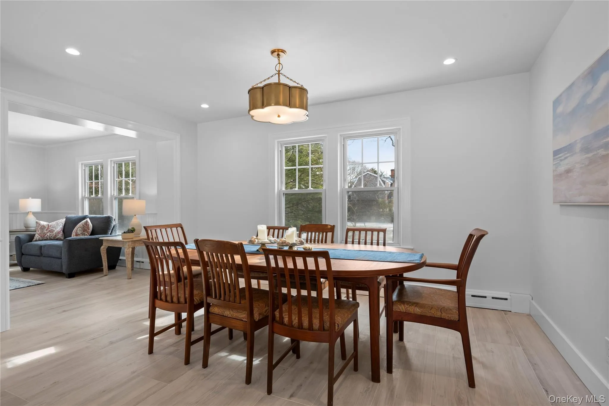 Dining room featuring light wood-type flooring, healthy amount of natural light, recessed lighting, and baseboard heating Dining room featuring light wood-type flooring, healthy amount of natural light, recessed lighting, and baseboard heating