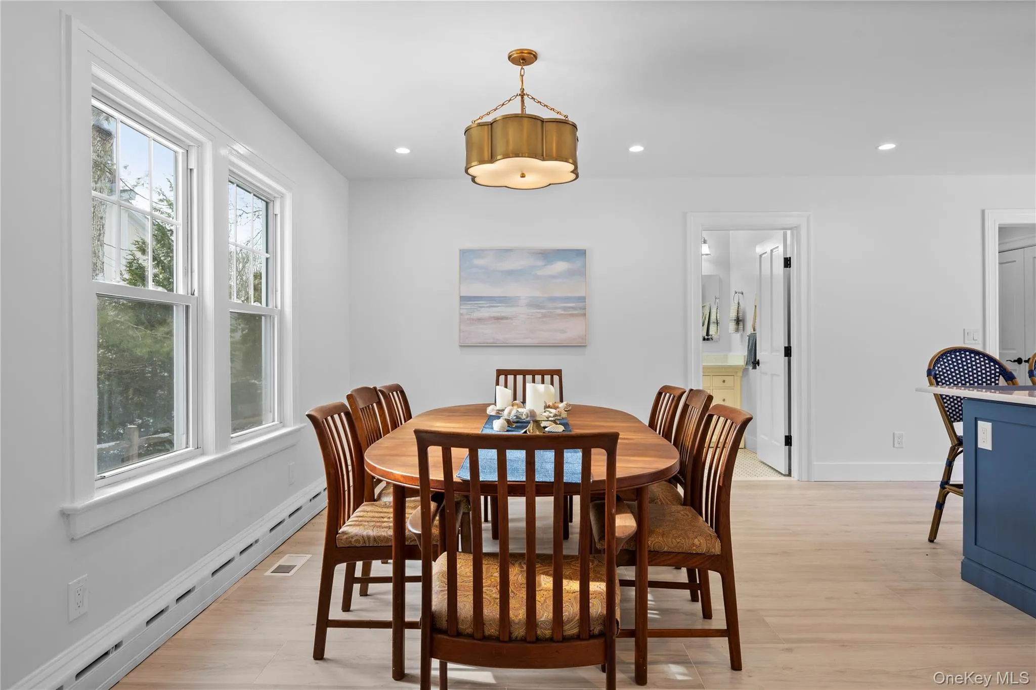 Dining area featuring a baseboard radiator, light wood-style flooring, and recessed lighting Dining area featuring a baseboard radiator, light wood-style flooring, and recessed lighting