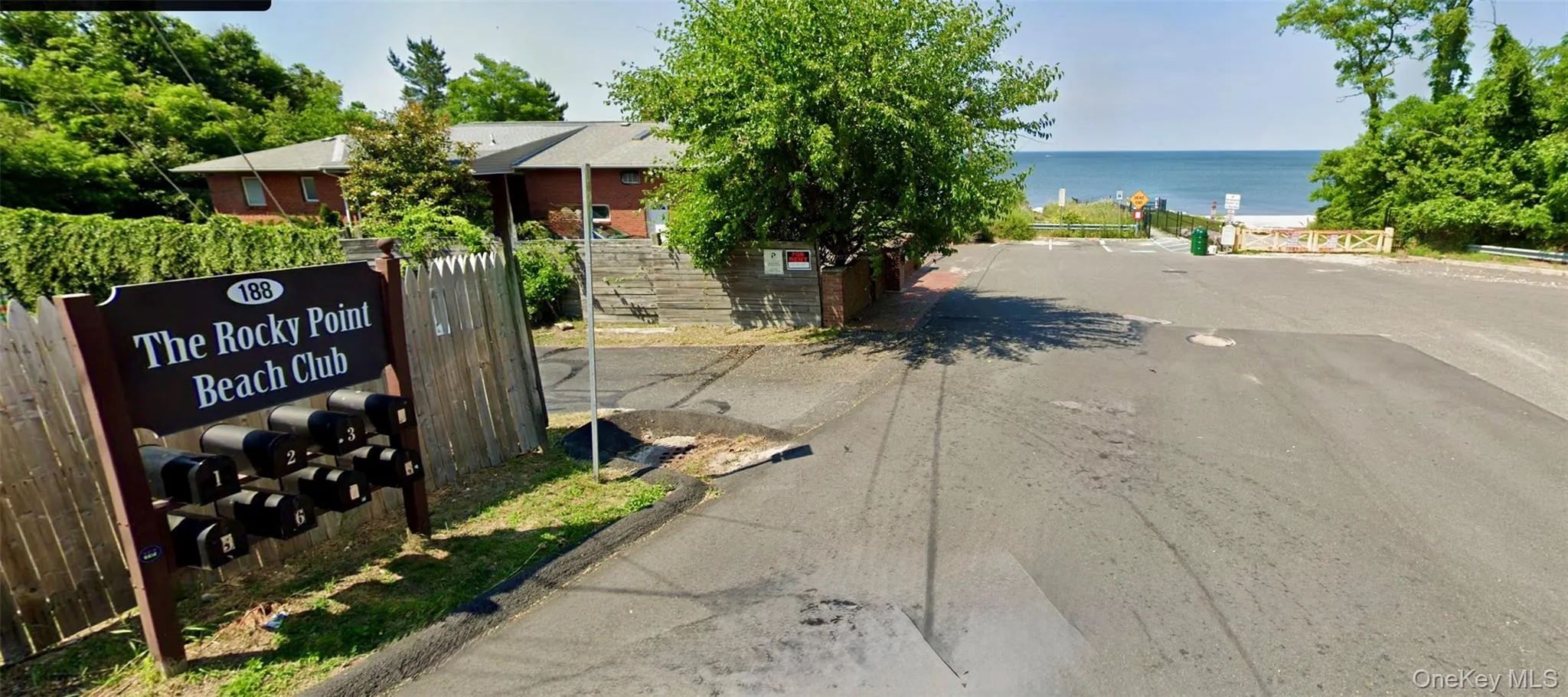 View of asphalt road with a water view and curbs View of asphalt road with a water view and curbs