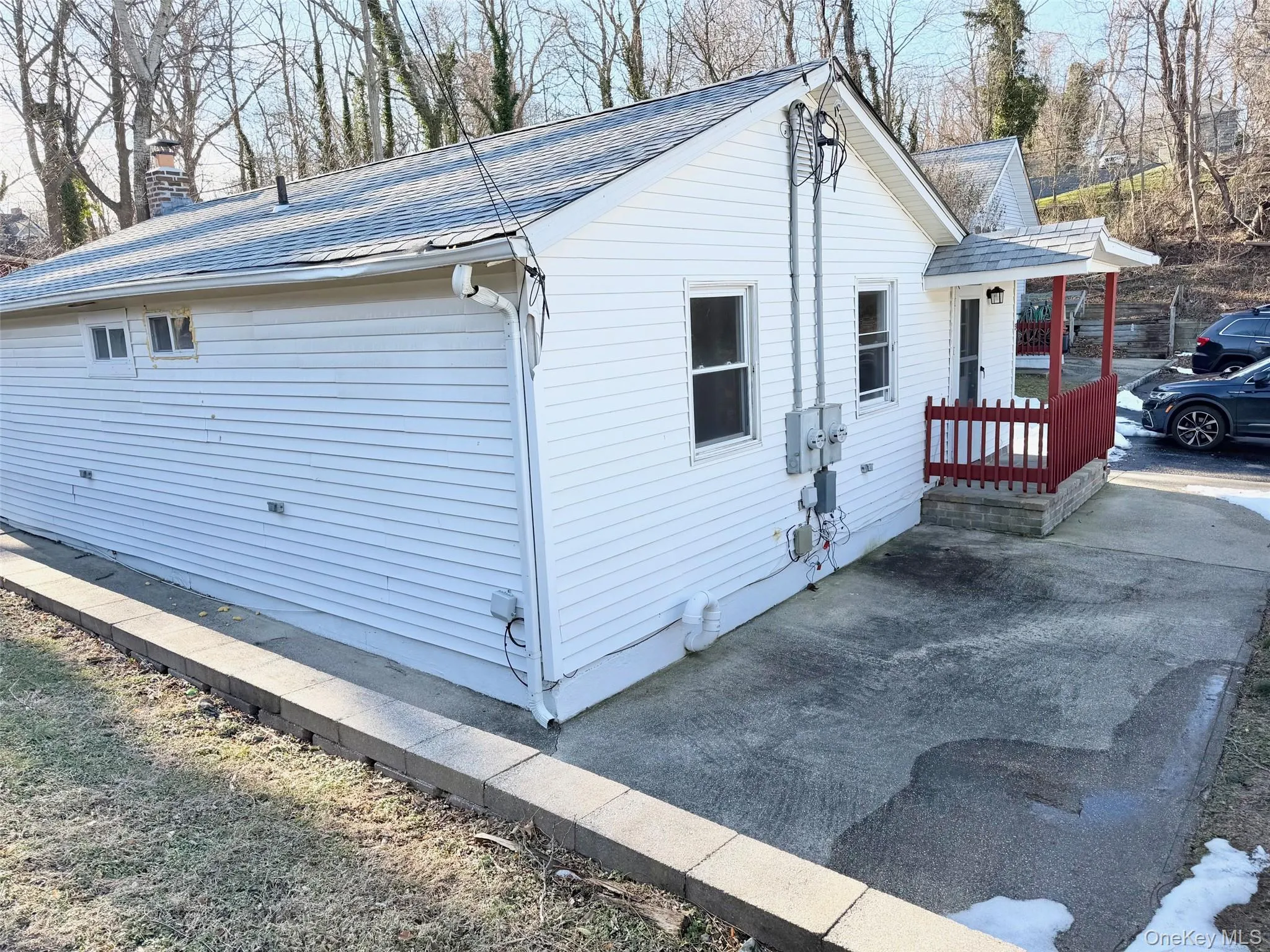 View of property exterior featuring a shingled roof and a chimney View of property exterior featuring a shingled roof and a chimney