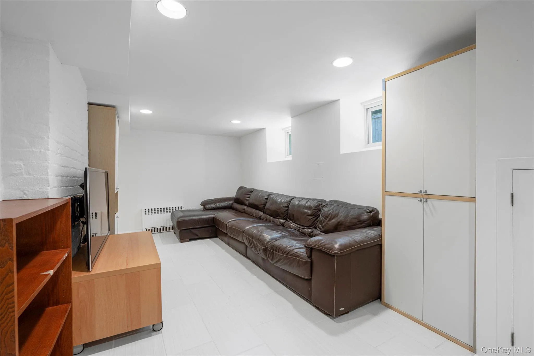 Finished basement with sofa and tv Finished basement with sofa and tv