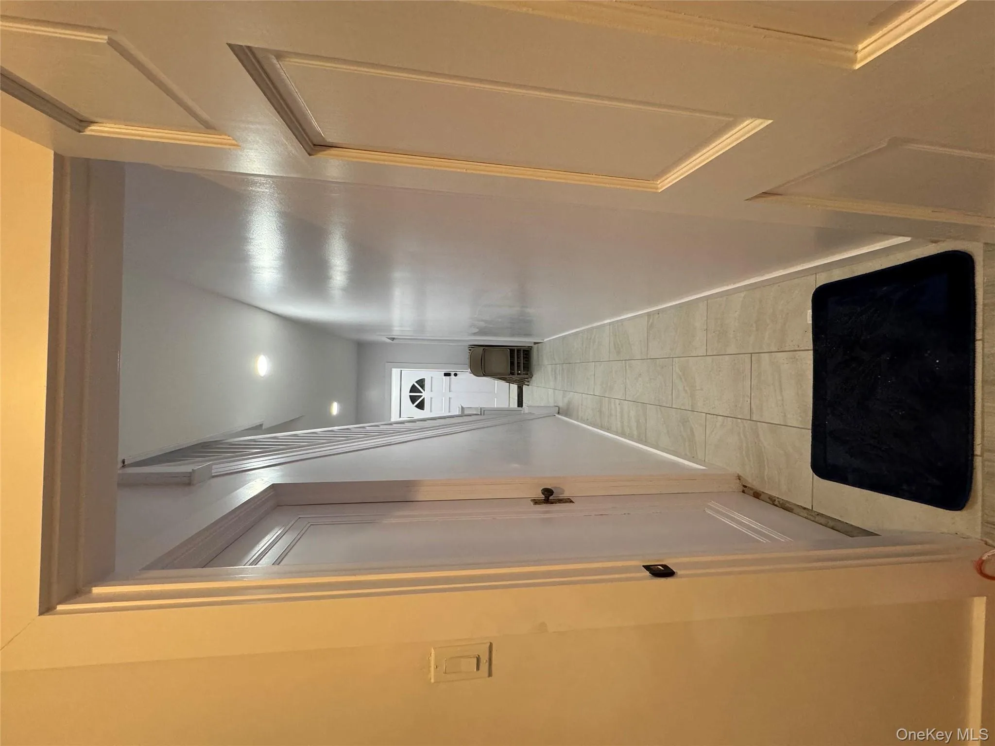 Hallway featuring light tile patterned floors and recessed lighting Hallway featuring light tile patterned floors and recessed lighting