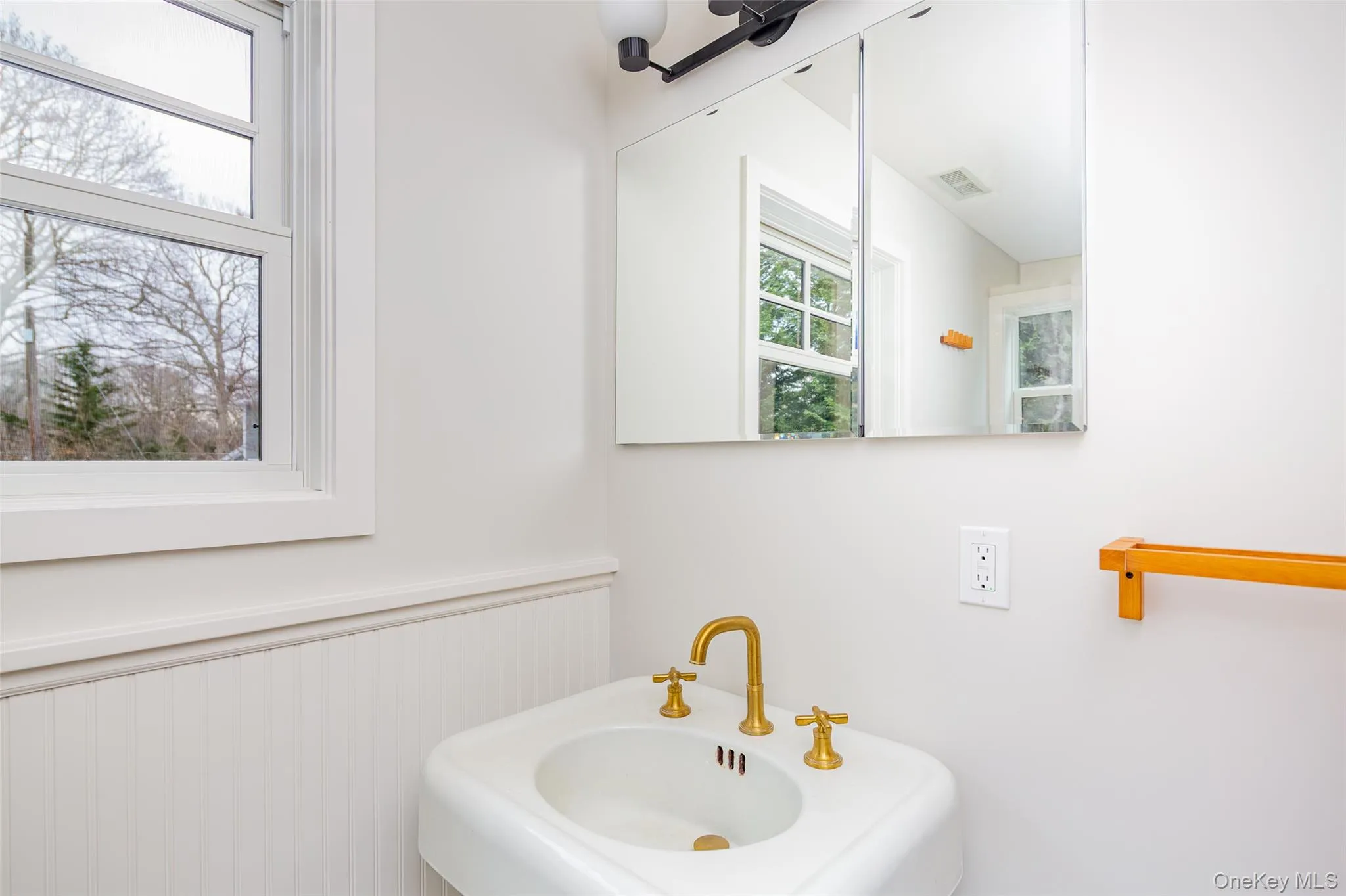 Bathroom featuring a sink and wainscoting Bathroom featuring a sink and wainscoting