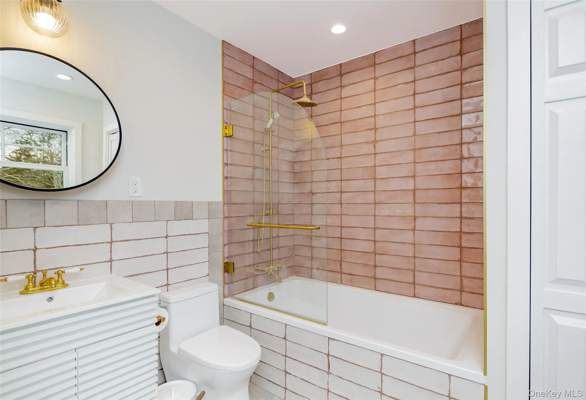 Full bathroom featuring tile walls, tiled shower / bath combo, vanity, and recessed lighting Full bathroom featuring tile walls, tiled shower / bath combo, vanity, and recessed lighting