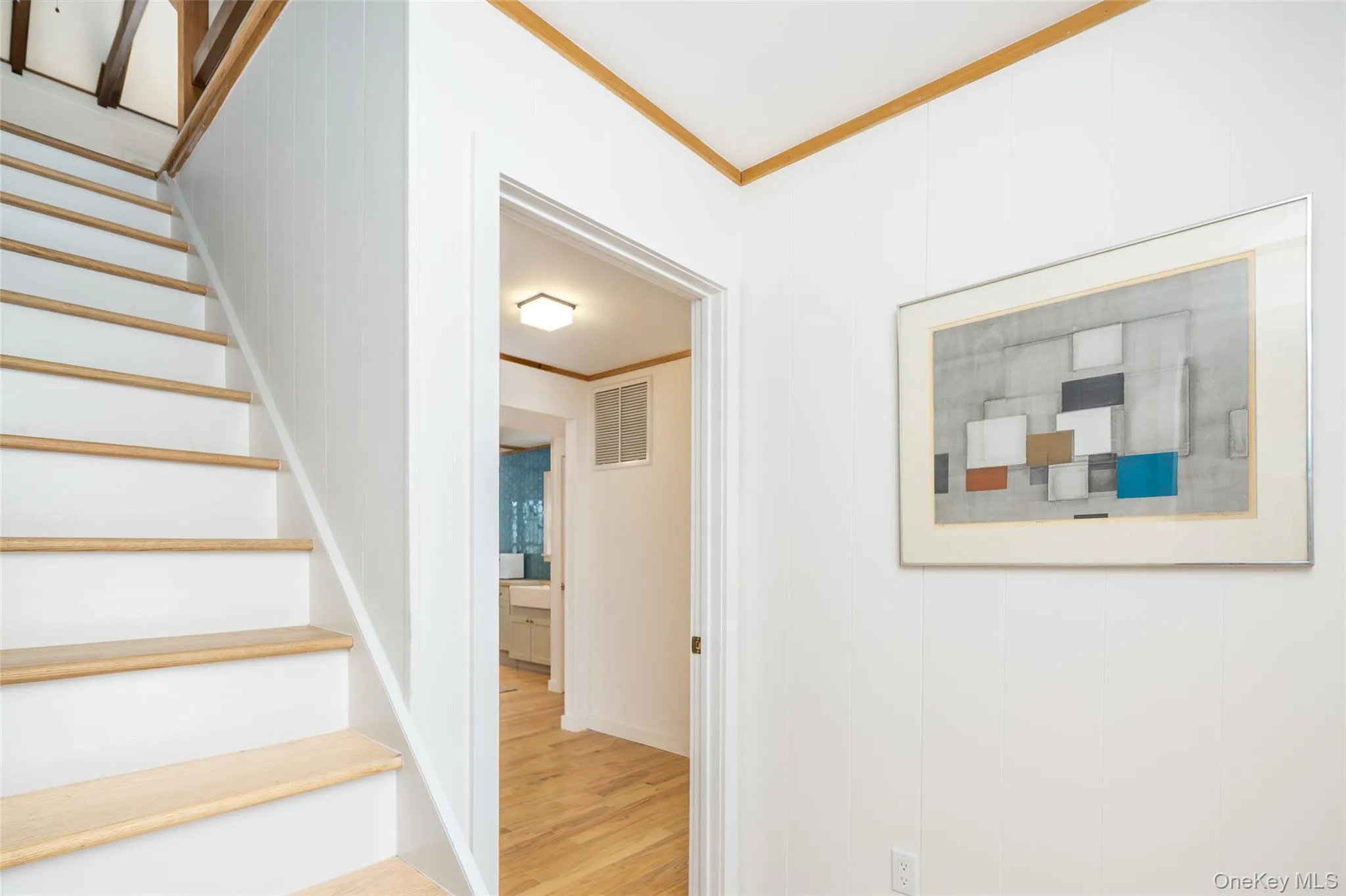 Stairs with crown molding and wood finished floors Stairs with crown molding and wood finished floors