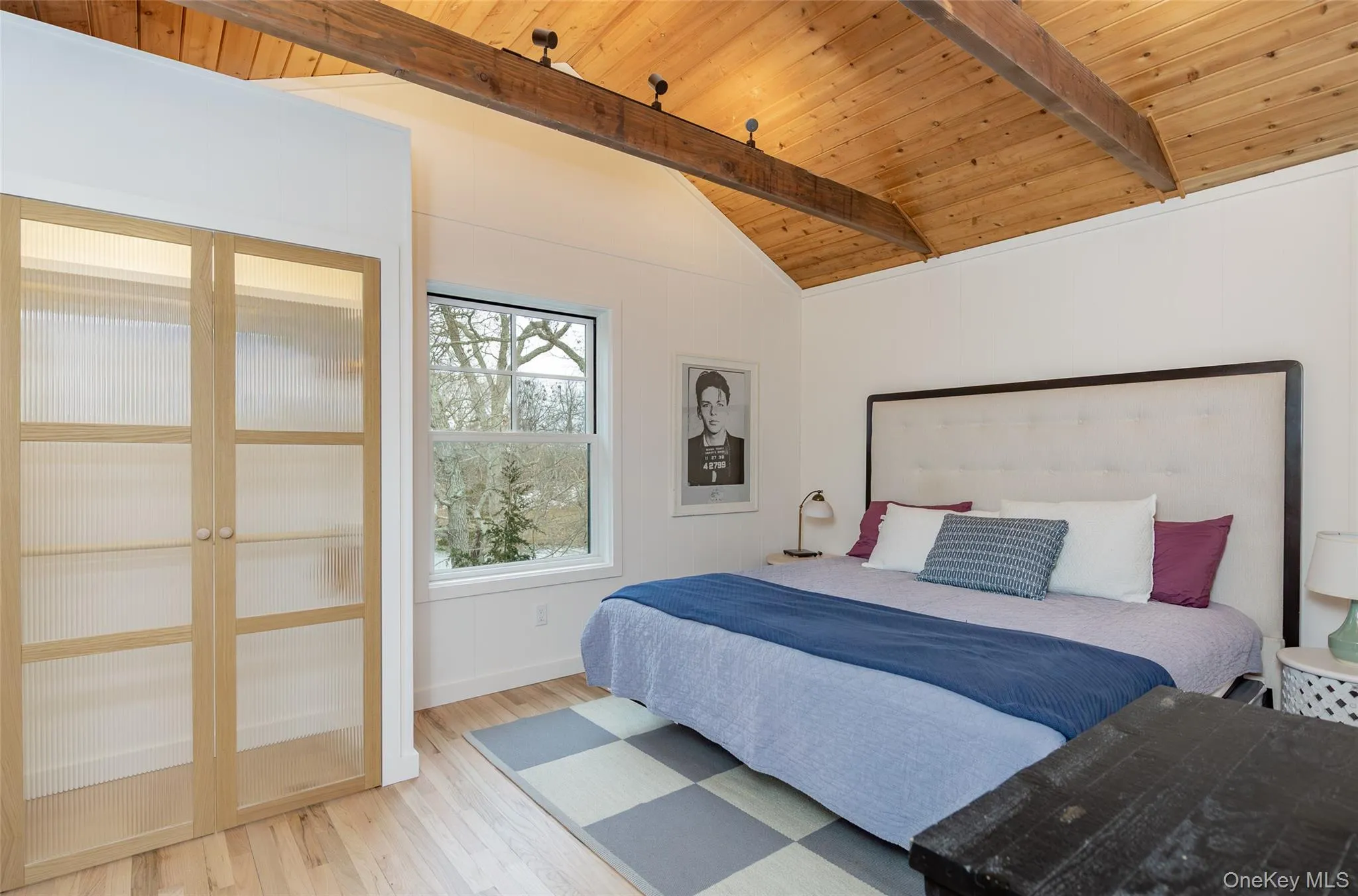 Bedroom featuring wood ceiling and wood finished floors Bedroom featuring wood ceiling and wood finished floors
