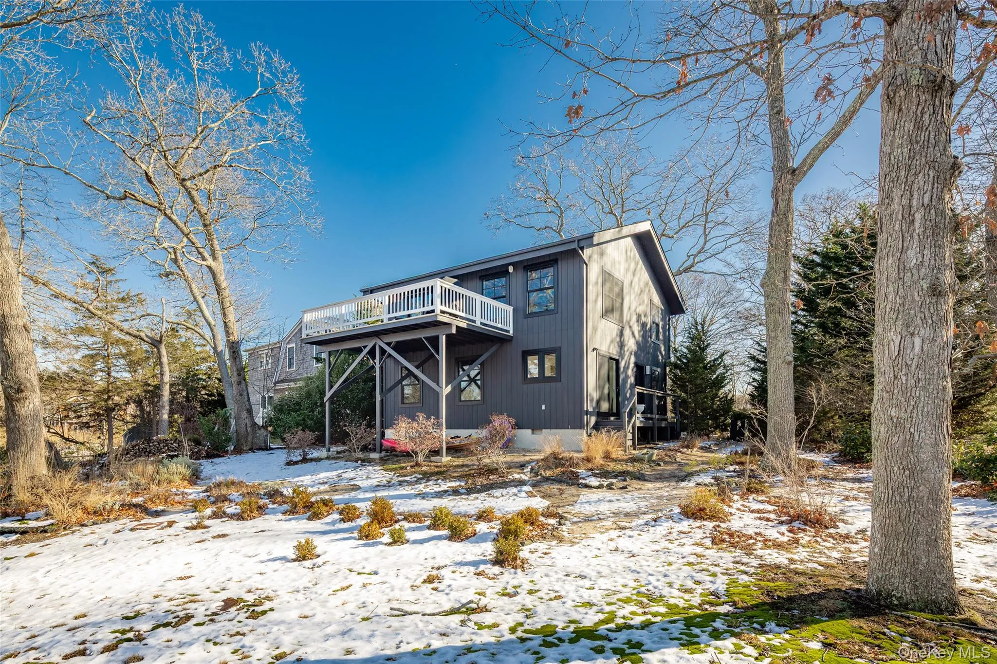 View of front of home featuring a wooden deck View of front of home featuring a wooden deck