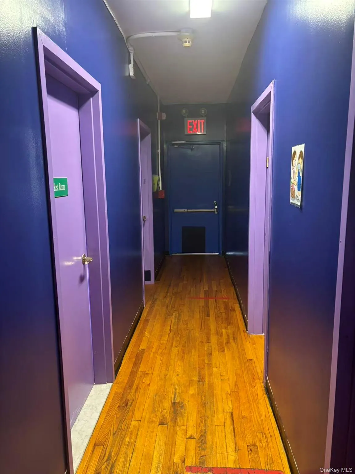 Corridor featuring light wood-style floors and elevator Corridor featuring light wood-style floors and elevator