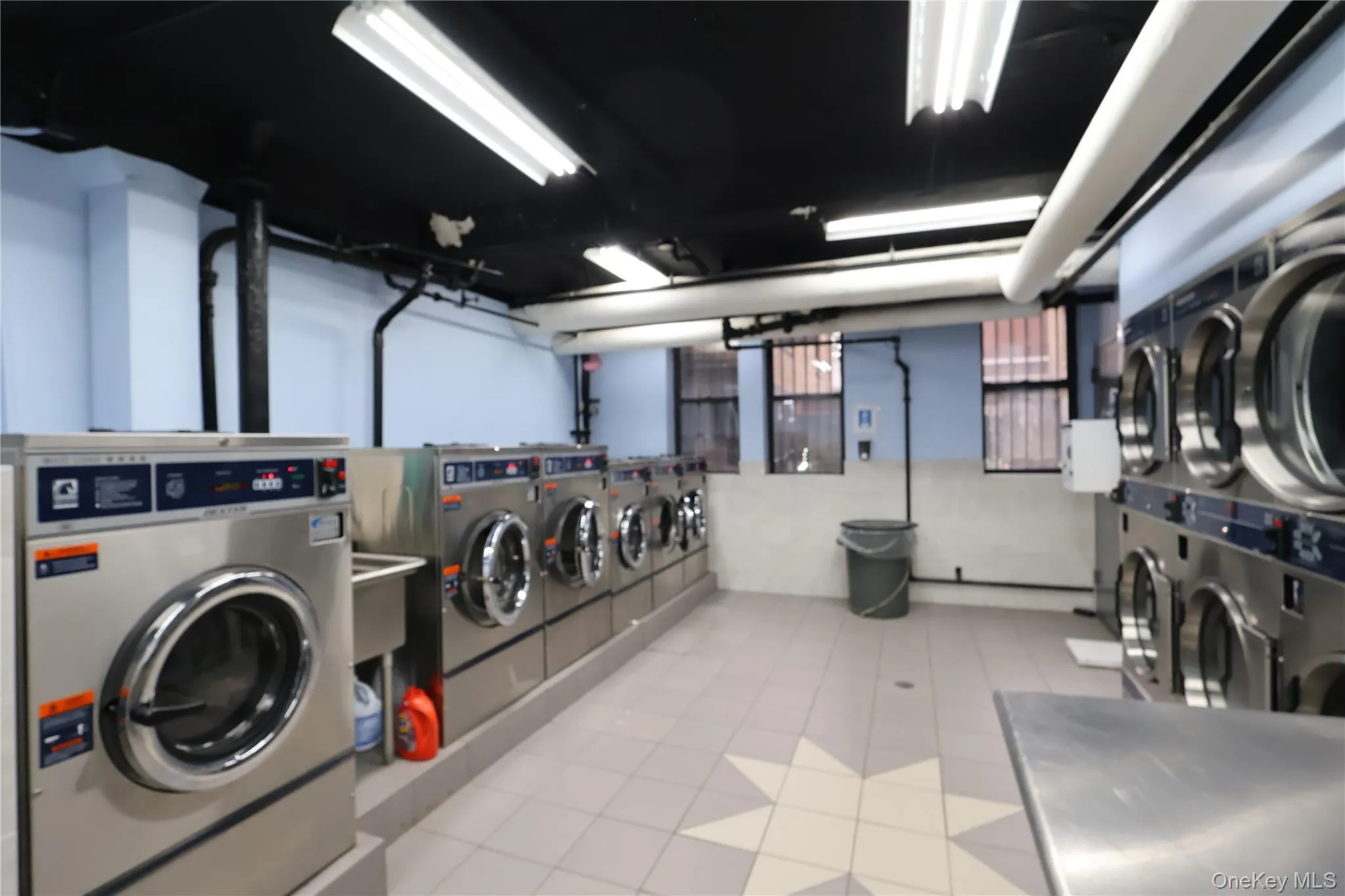 Community laundry room with washer and dryer and stacked washer / dryer Community laundry room with washer and dryer and stacked washer / dryer