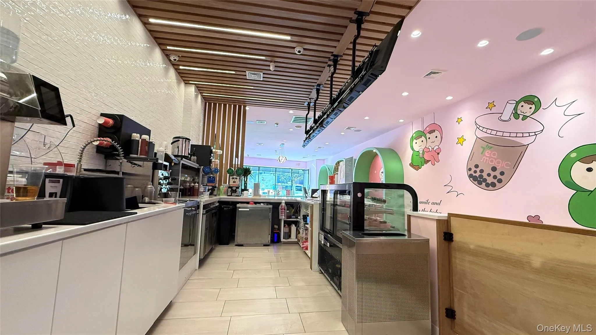 Kitchen with light tile patterned flooring, refrigerator, white cabinetry, modern cabinets, and visible vents Kitchen with light tile patterned flooring, refrigerator, white cabinetry, modern cabinets, and visible vents