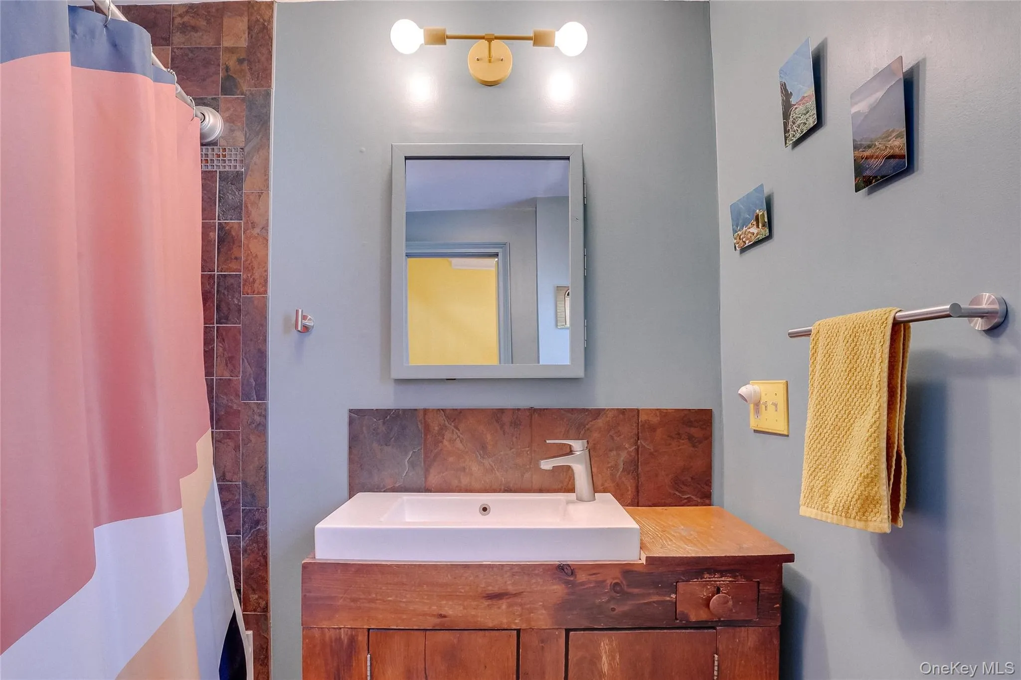 Full bath with wood vanity. Full bath with wood vanity.