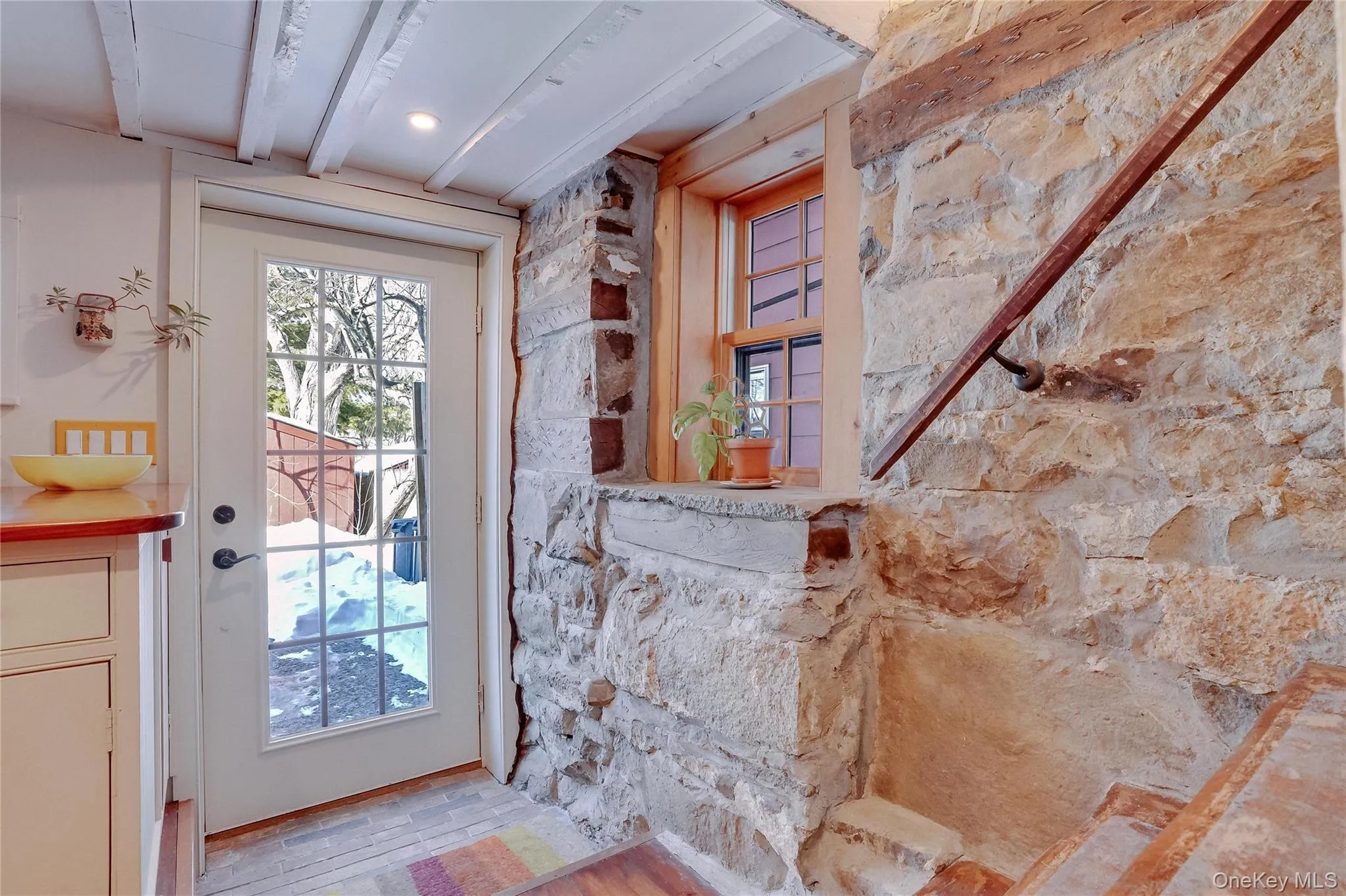 Stairwell leading to kitchen/lower level. French door leading to back yard. Stairwell leading to kitchen/lower level. French door leading to back yard.