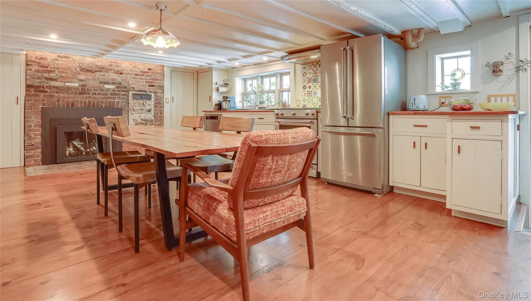 Kitchen with hardwood floors, stainless appliances and working gas fireplace. Kitchen with hardwood floors, stainless appliances and working gas fireplace.