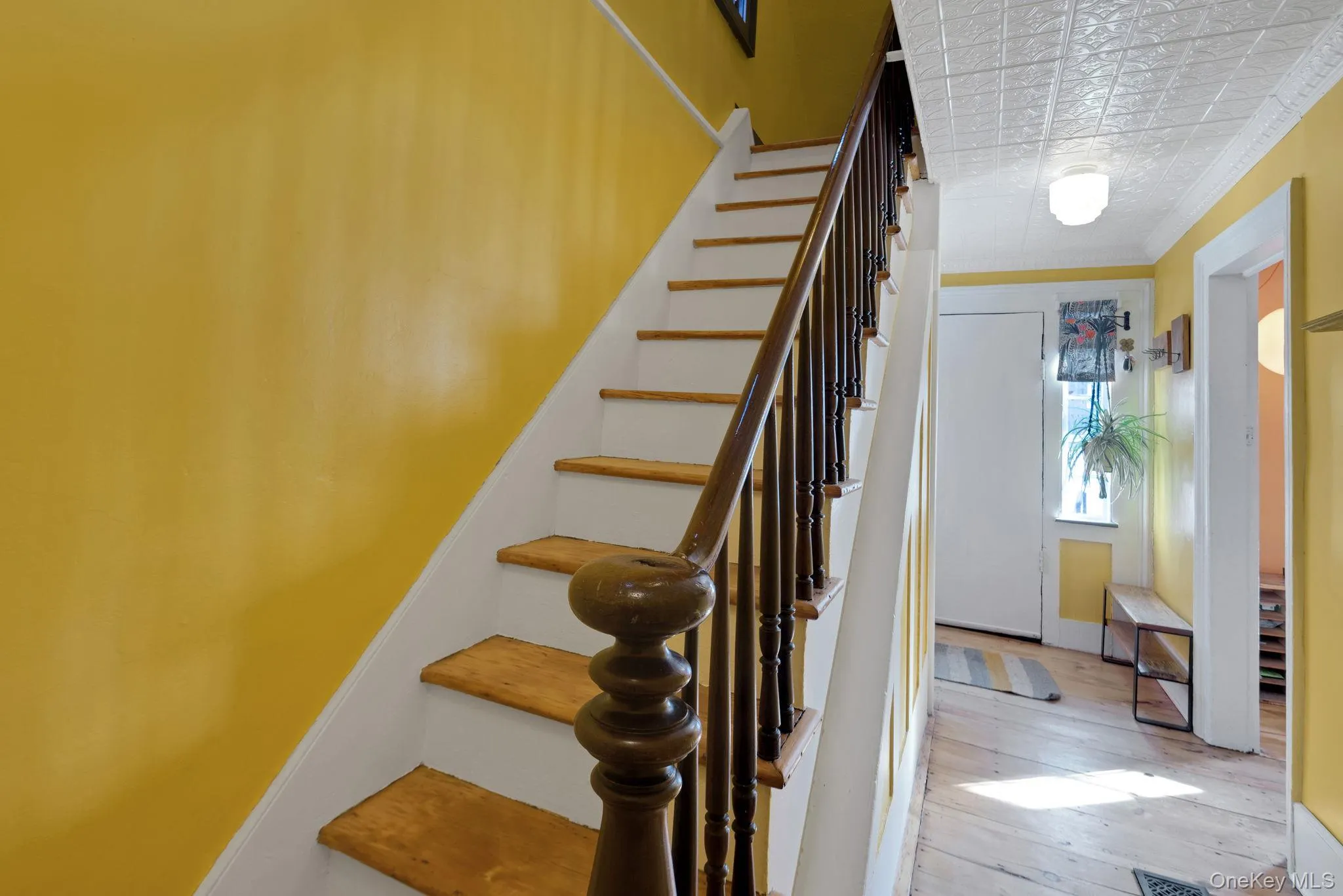 Hallway with tin ceiling and original bannister. Hallway with tin ceiling and original bannister.