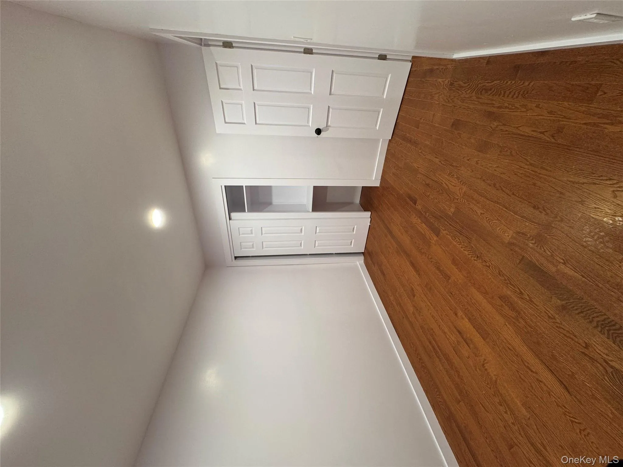 Unfurnished bedroom with a closet, dark wood-type flooring, and recessed lighting Unfurnished bedroom with a closet, dark wood-type flooring, and recessed lighting