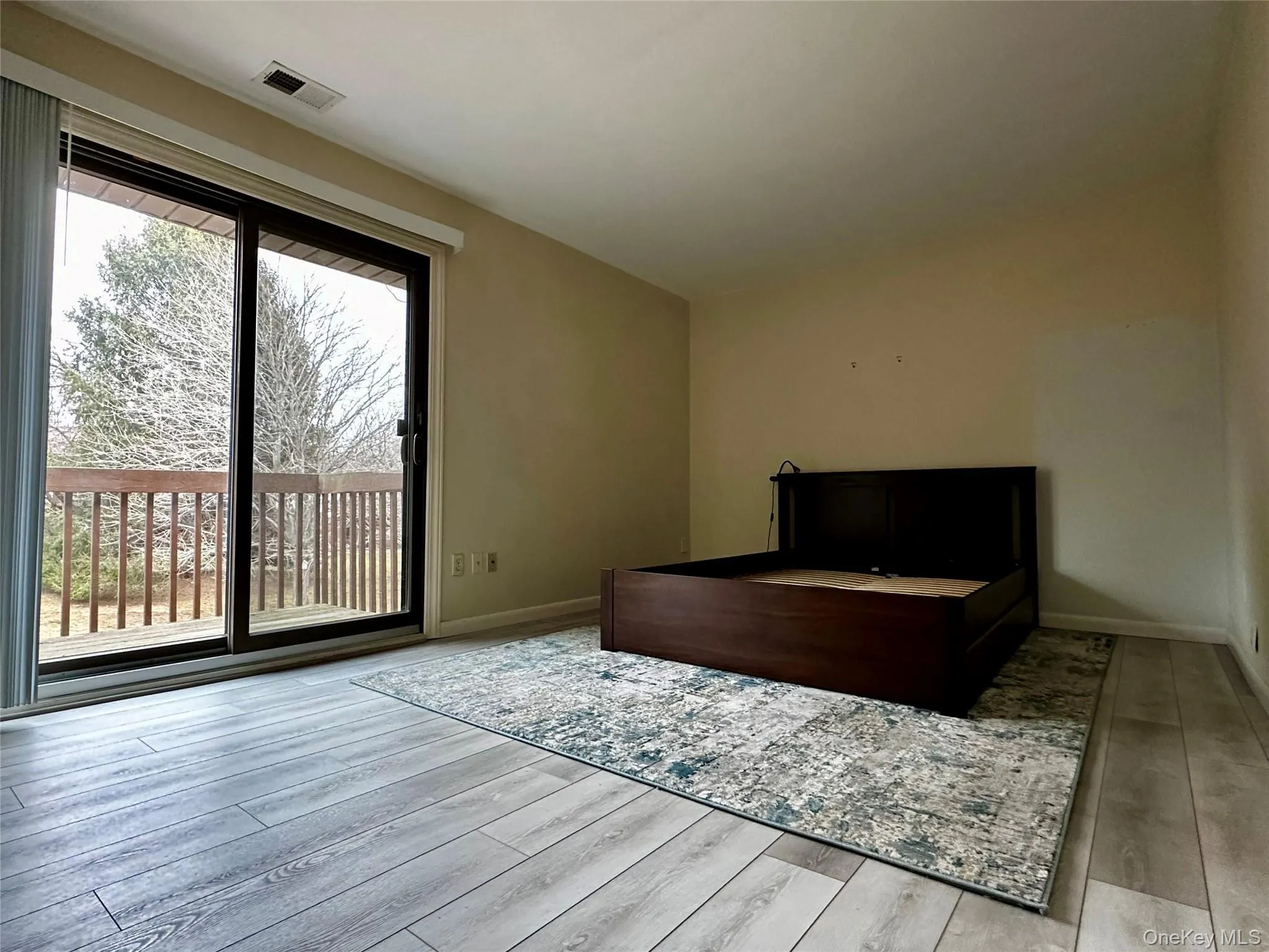Bedroom featuring access to outside and light vinyl plankl floors Bedroom featuring access to outside and light vinyl plankl floors