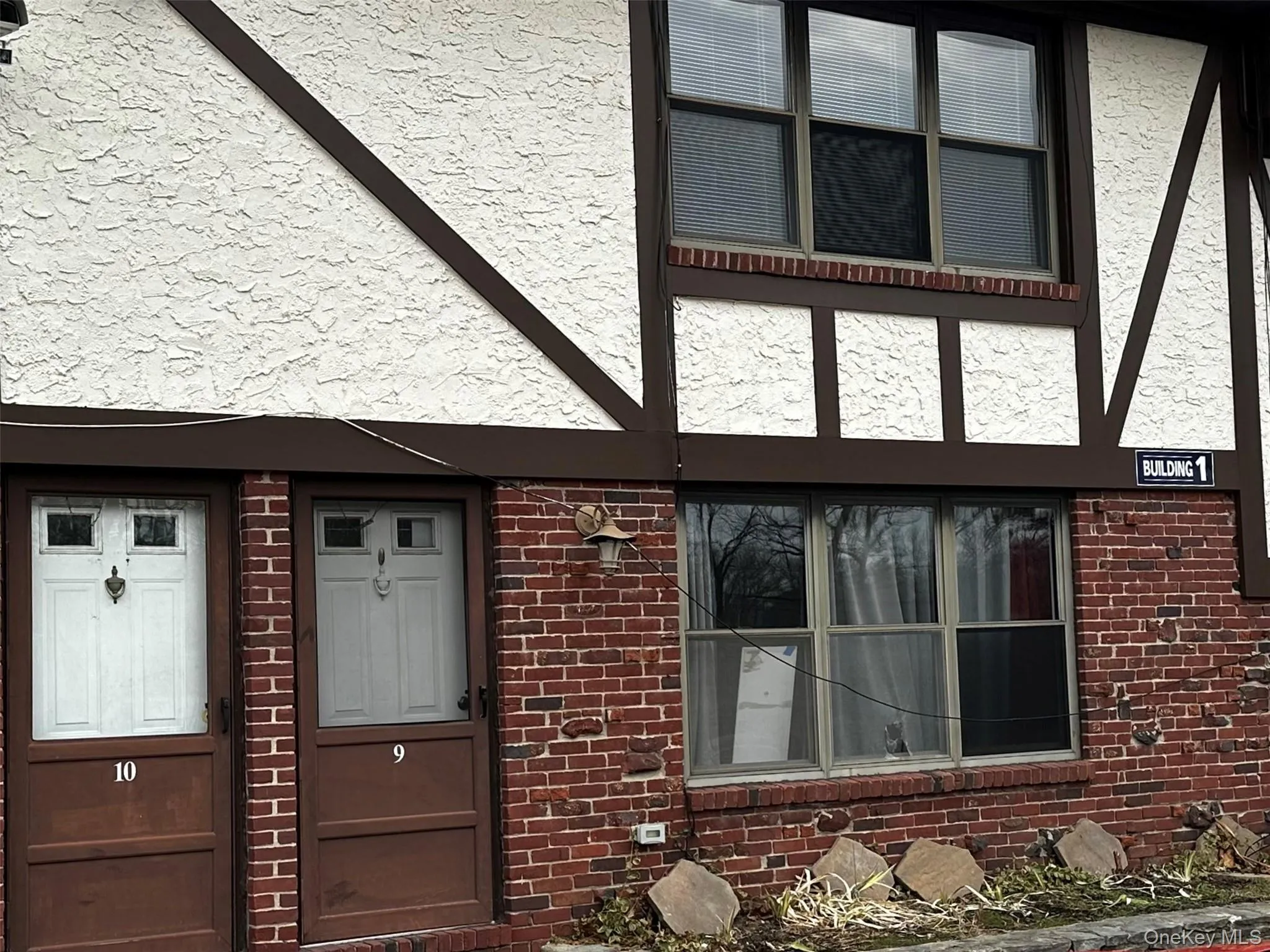 Entrance to property with stucco siding and brick siding Entrance to property with stucco siding and brick siding