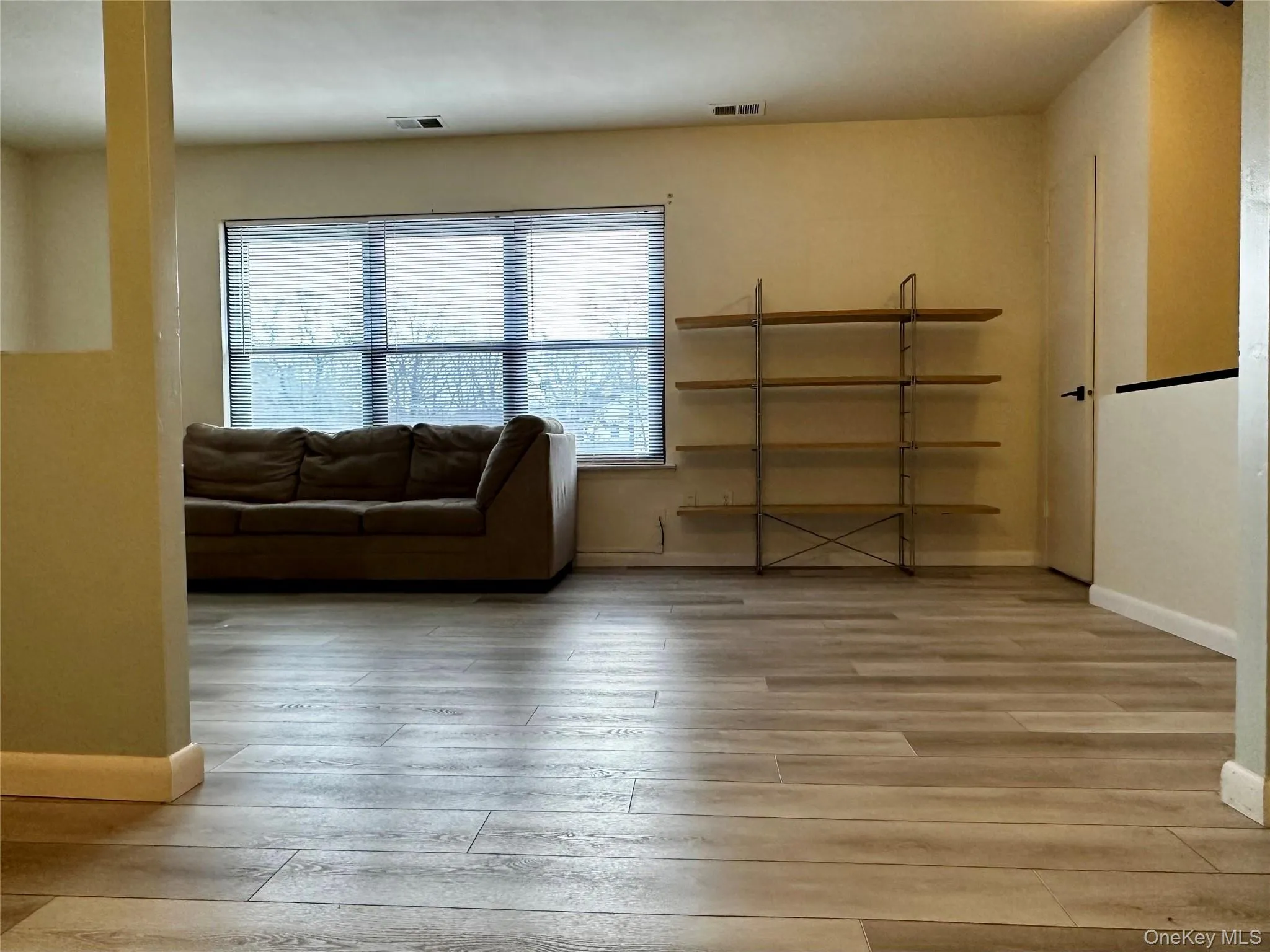 Living area with baseboards and light vinyl flooring Living area with baseboards and light vinyl flooring