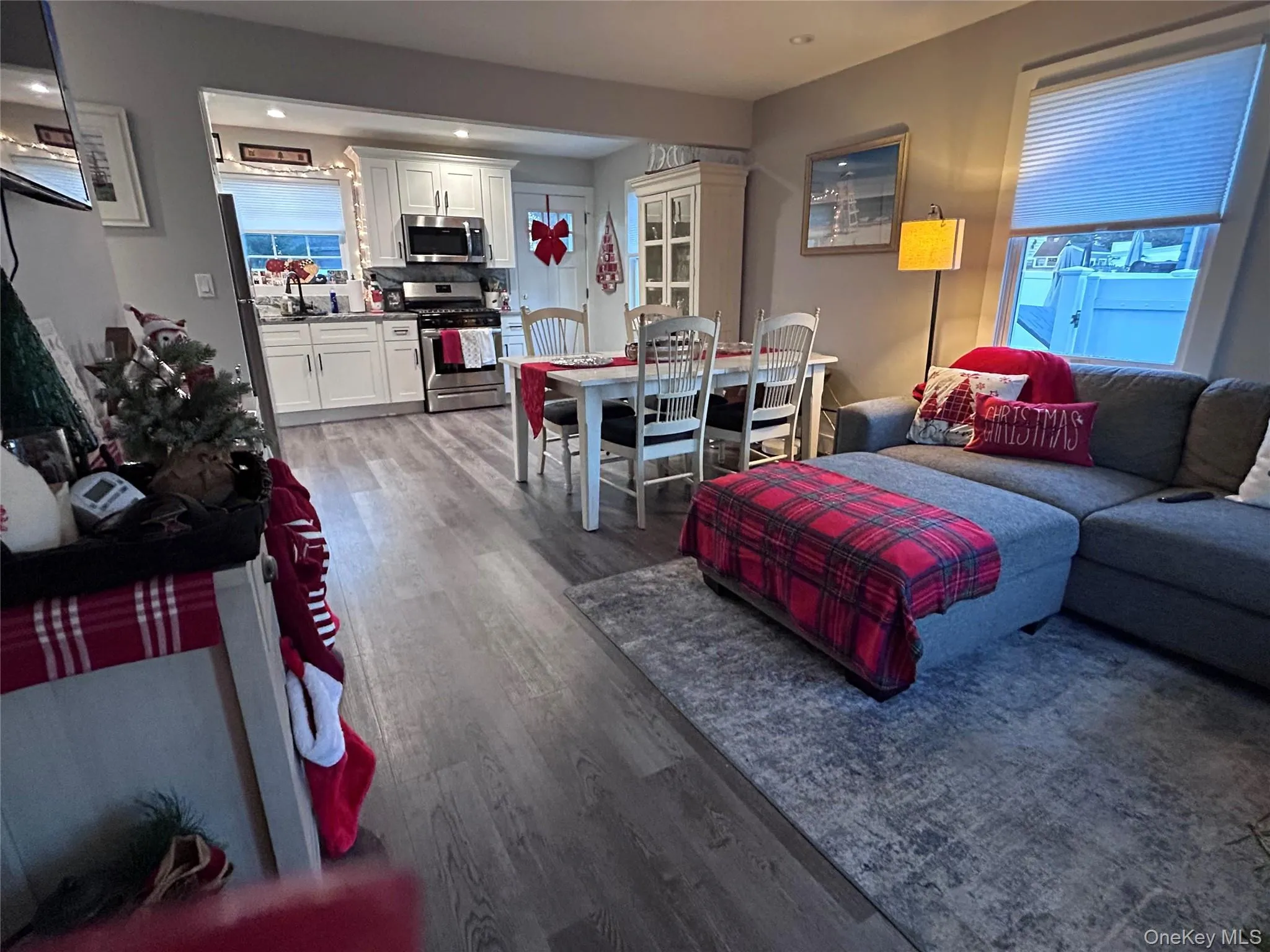 Living room featuring dark wood-style floors and recessed lighting Living room featuring dark wood-style floors and recessed lighting
