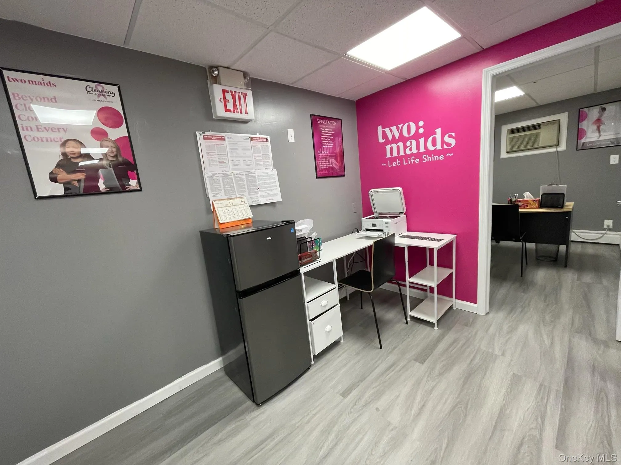 Office featuring a paneled ceiling, a wall unit AC, and baseboard heating Office featuring a paneled ceiling, a wall unit AC, and baseboard heating