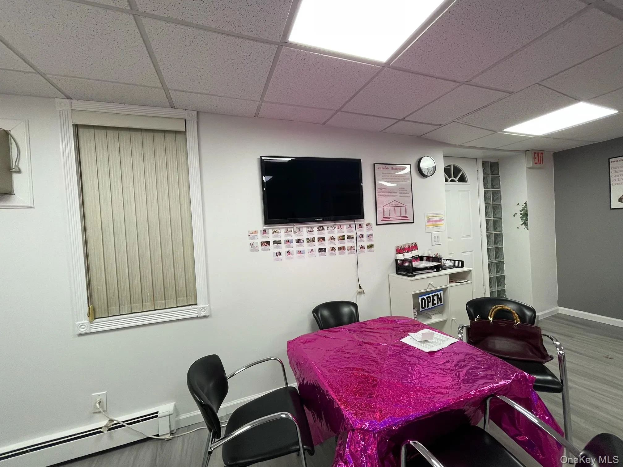 Conference Area W.baseboard heating unit, a paneled ceiling, and wood finished floors Conference Area W.baseboard heating unit, a paneled ceiling, and wood finished floors