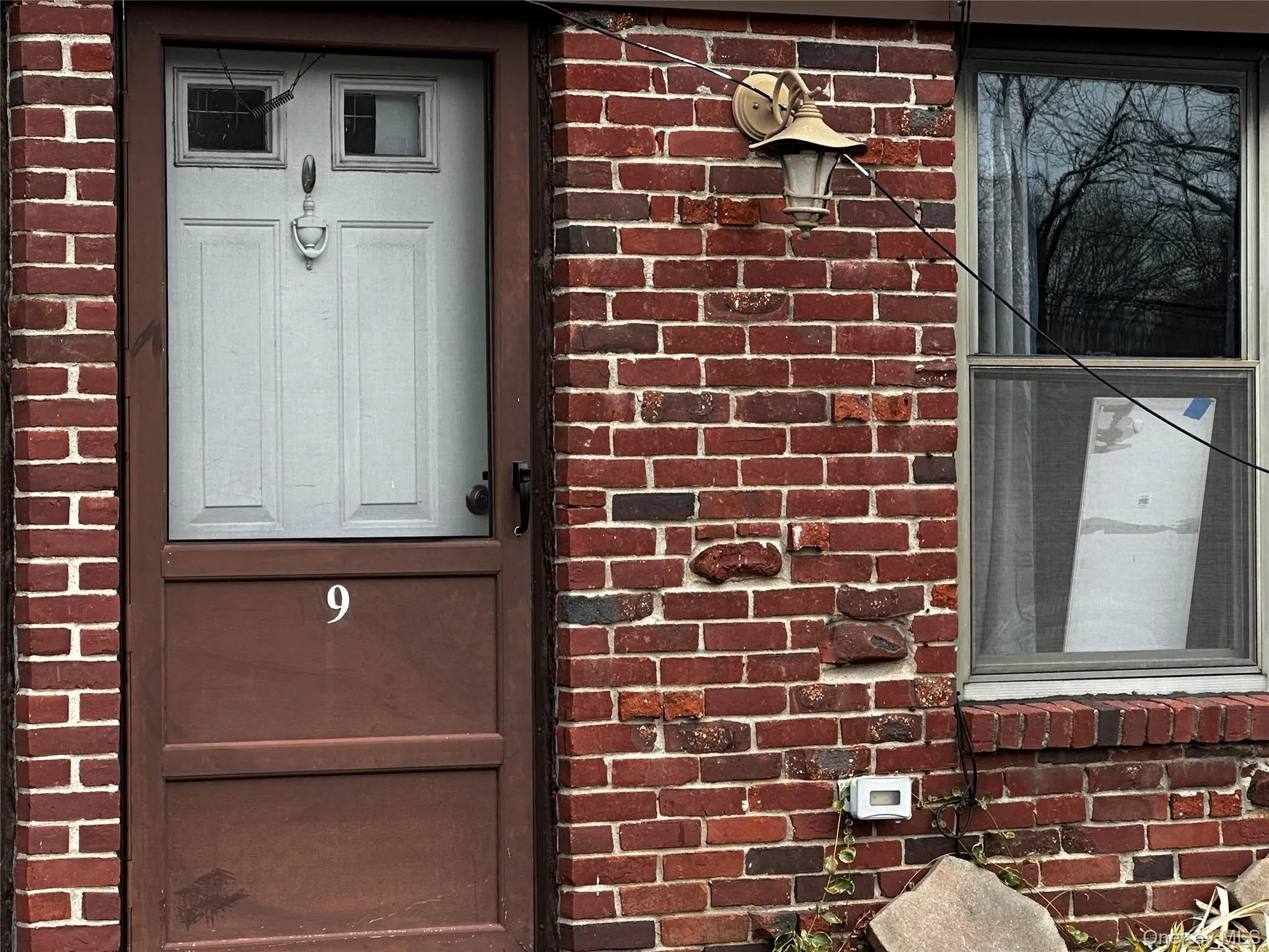 Property entrance with brick siding Property entrance with brick siding