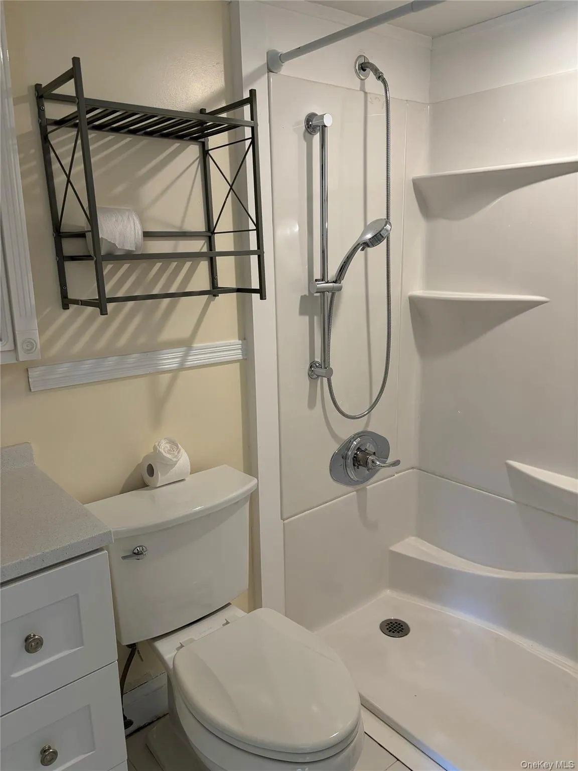 Bathroom featuring a shower and vanity Bathroom featuring a shower and vanity