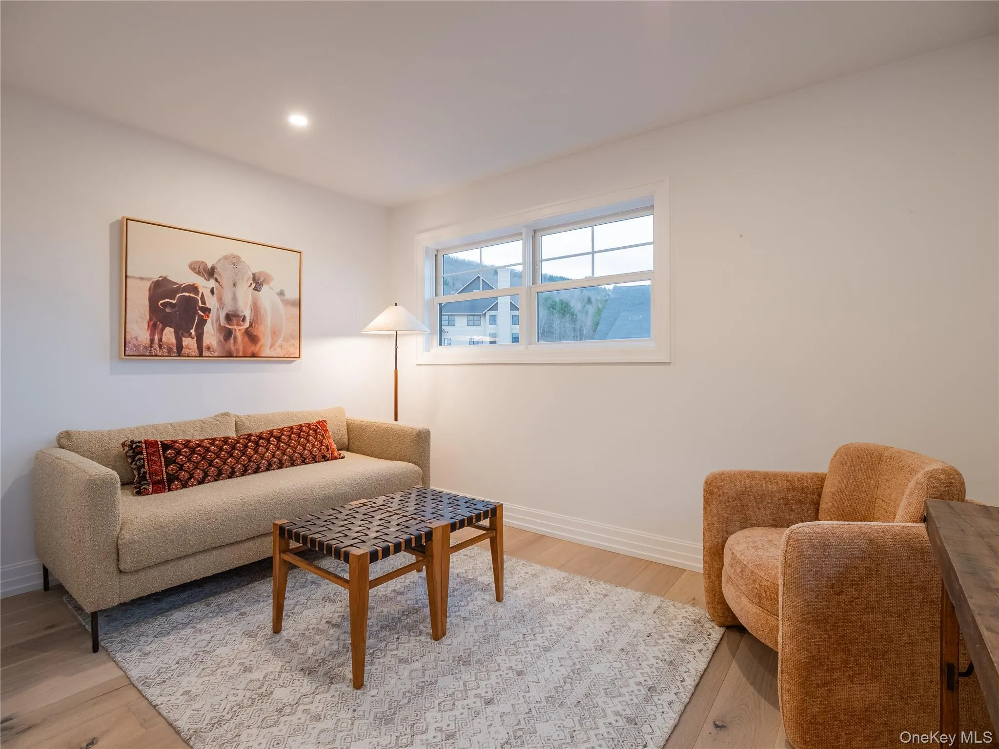 Living room with light wood-style floors and recessed lighting Living room with light wood-style floors and recessed lighting
