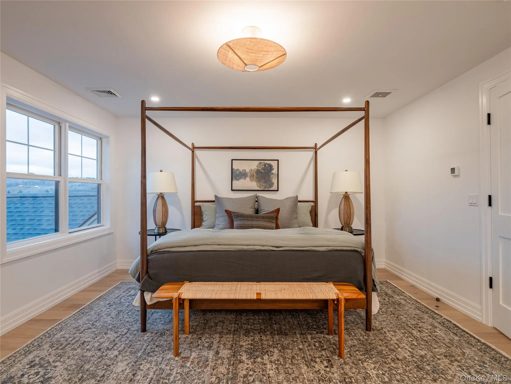 Bedroom featuring light wood-style floors and recessed lighting Bedroom featuring light wood-style floors and recessed lighting
