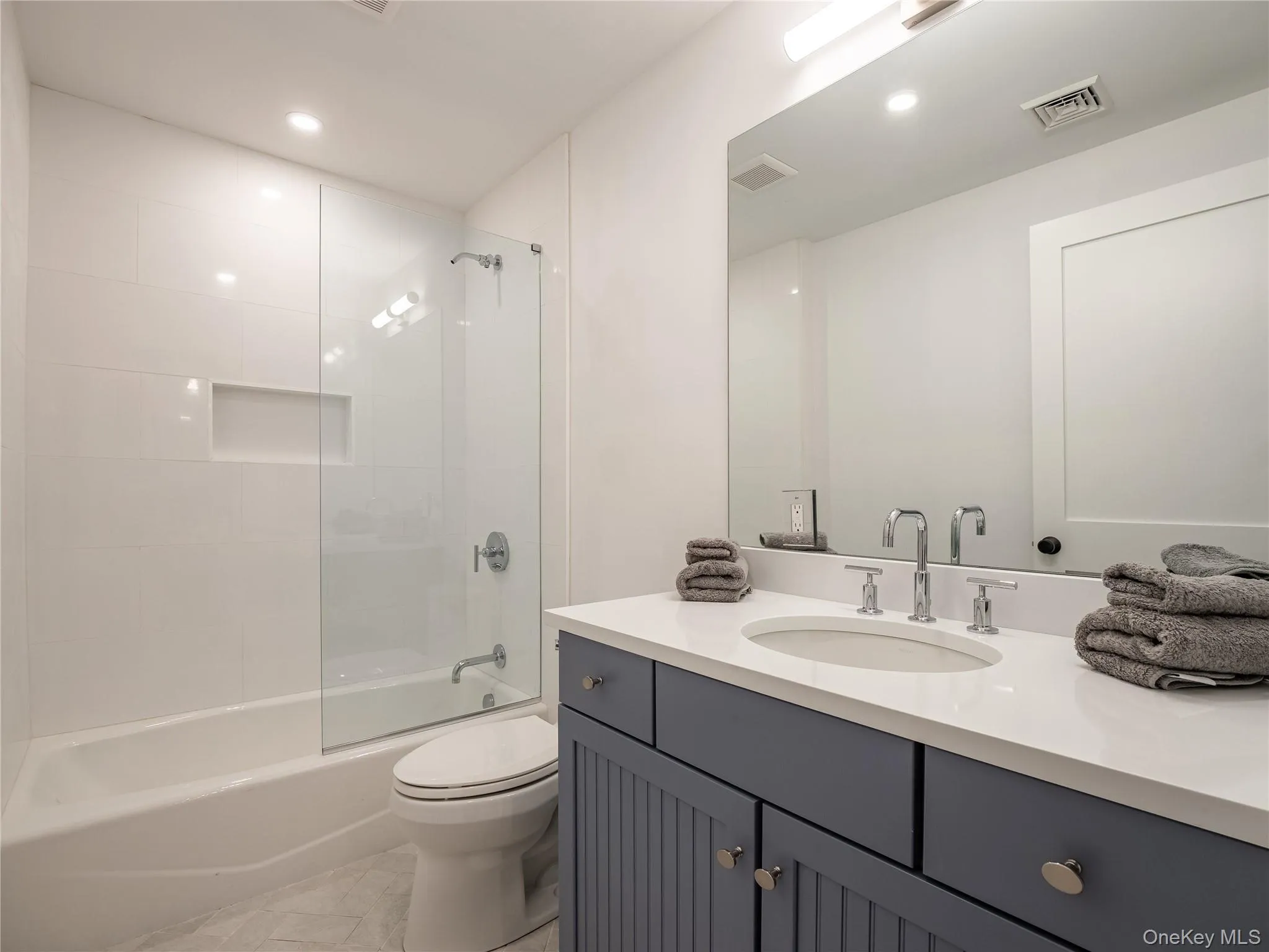 Full bath with vanity and combined bath / shower with glass door Full bath with vanity and combined bath / shower with glass door