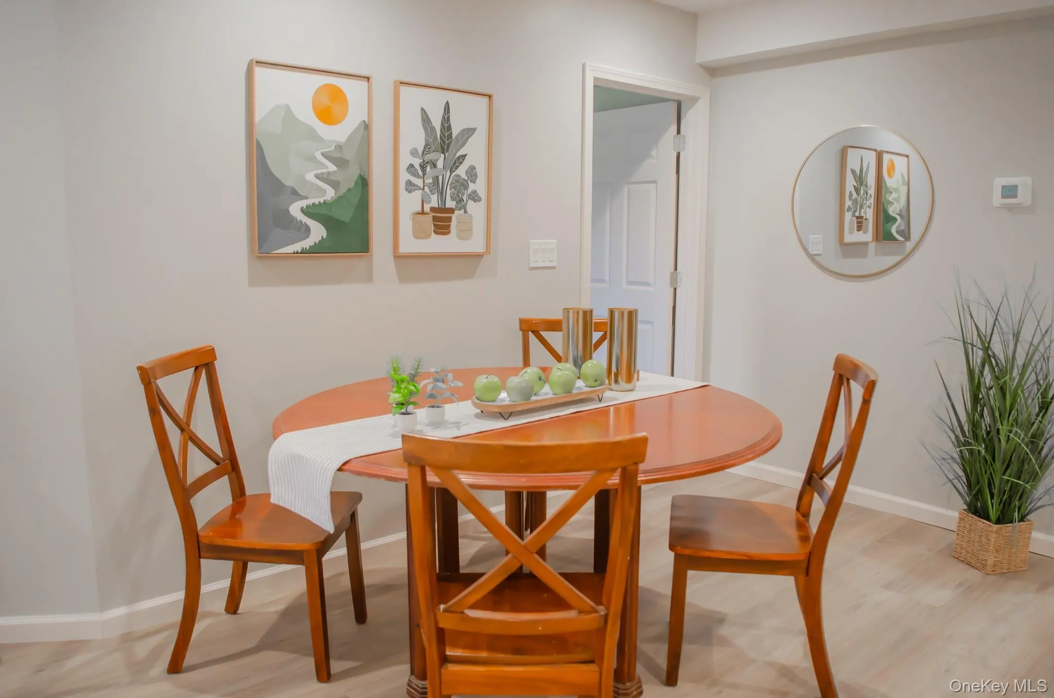 Dining room with light wood-style flooring and baseboards Dining room with light wood-style flooring and baseboards
