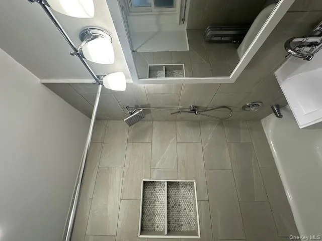 Bathroom featuring tub / shower combination and vanity Bathroom featuring tub / shower combination and vanity