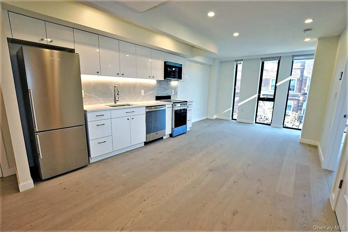 Kitchen with white cabinetry, stainless steel appliances, light countertops, tasteful backsplash, and recessed lighting Kitchen with white cabinetry, stainless steel appliances, light countertops, tasteful backsplash, and recessed lighting