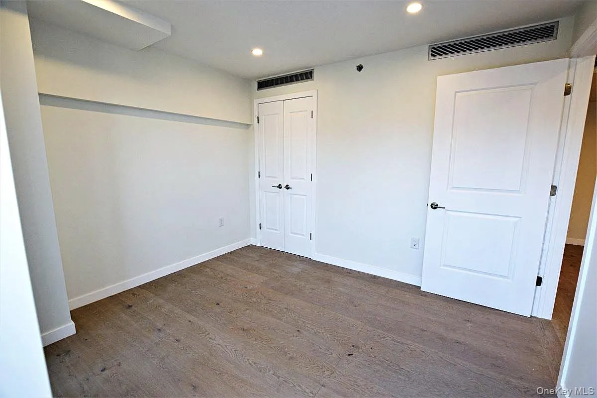 Unfurnished bedroom featuring recessed lighting, dark wood finished floors, and a closet Unfurnished bedroom featuring recessed lighting, dark wood finished floors, and a closet