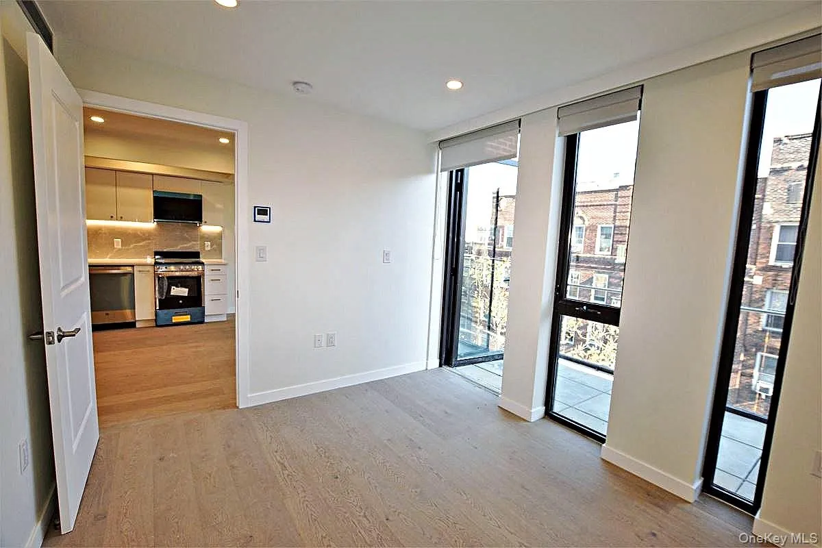 Unfurnished room featuring light wood-style floors, recessed lighting, and floor to ceiling windows Unfurnished room featuring light wood-style floors, recessed lighting, and floor to ceiling windows