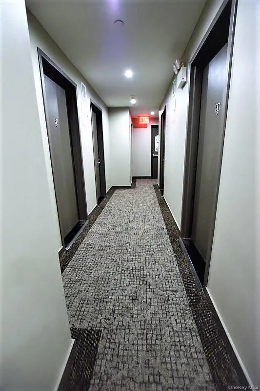 Hall with baseboards and dark floors Hall with baseboards and dark floors